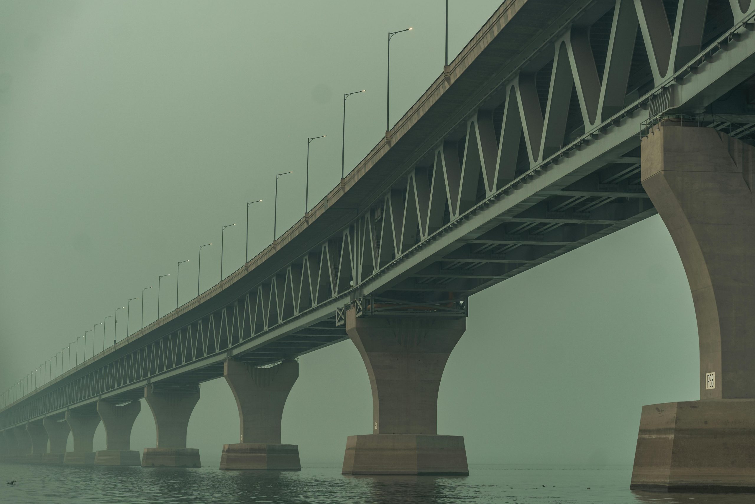 A dramatic bridge in Madaripur, Dhaka Division, Bangladesh shrouded in fog.